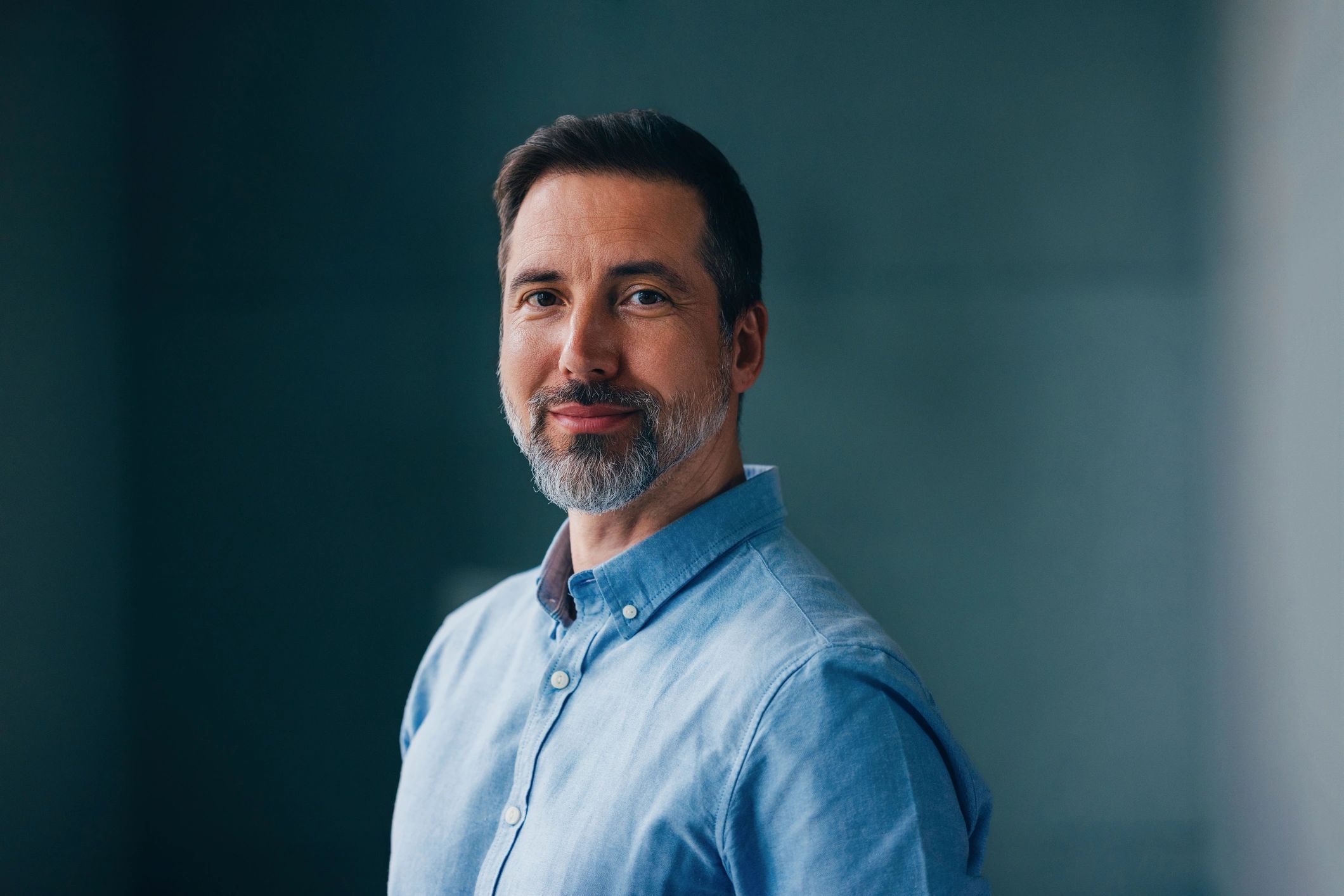 Professional headshot of a person in business attire