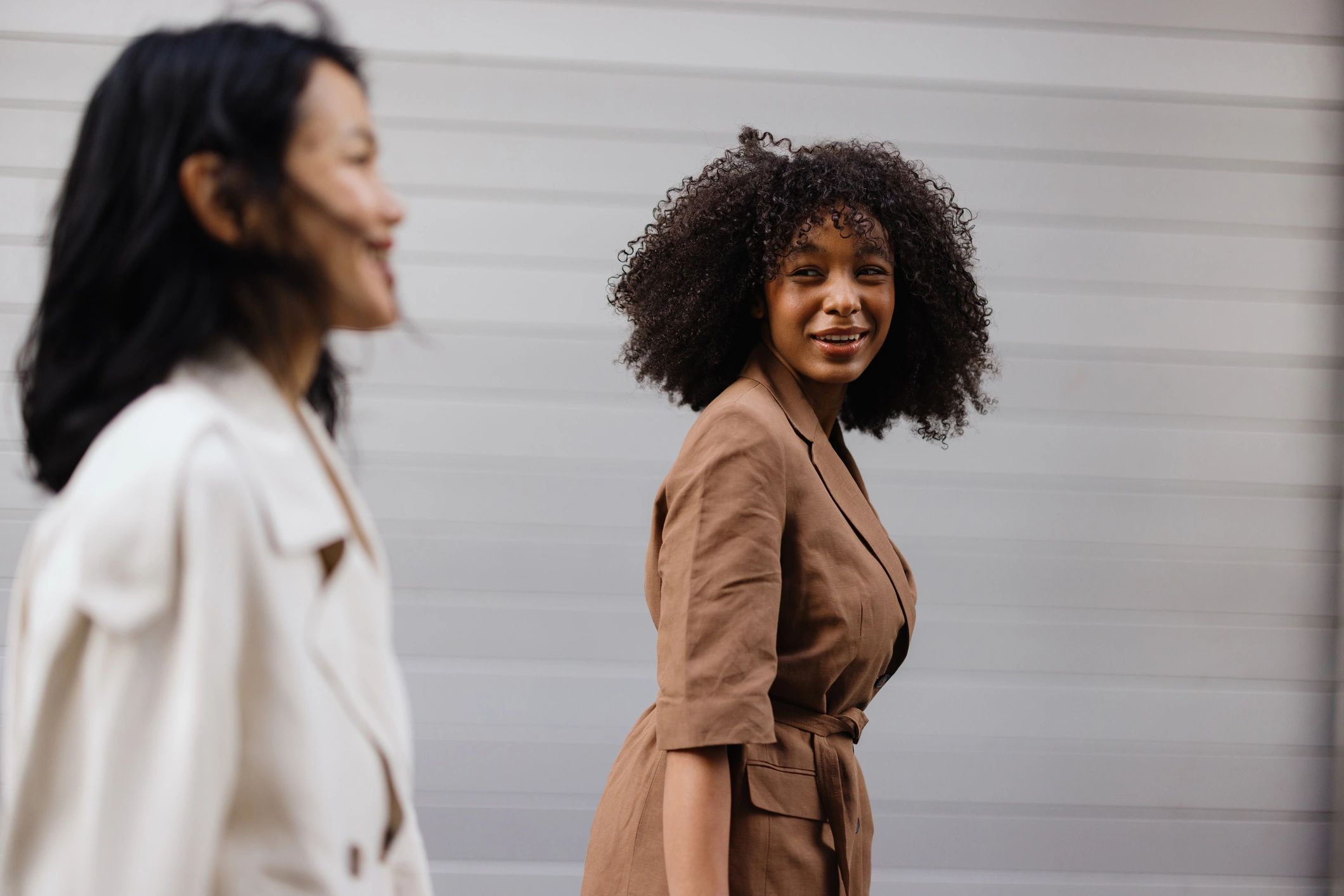 Two people walking in the city during a lifestyle portrait session