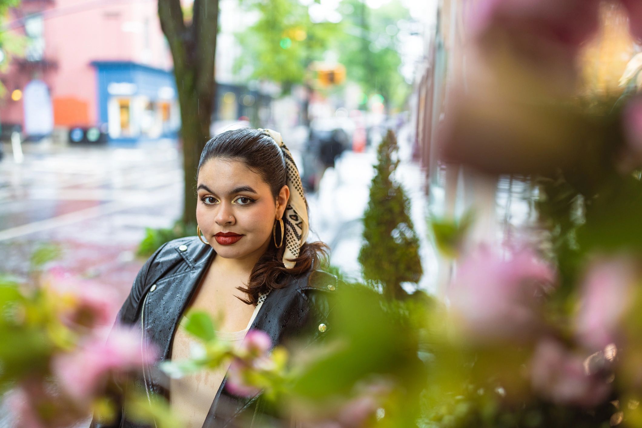 Outdoor portrait among flowers with city background
